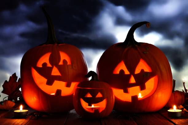istock Halloween Jack o Lantern night scene against dark clouds 1030147978