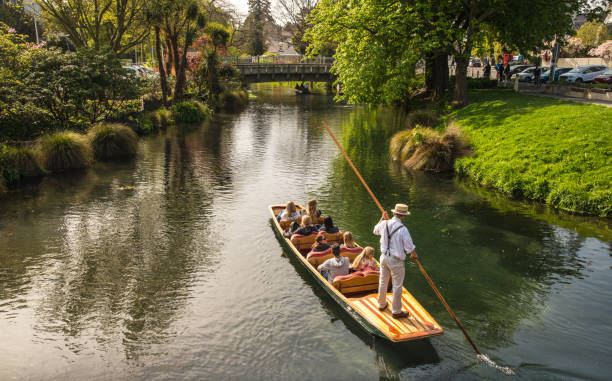 Tourist enjoying with Punting on the Avon River one of the top tourist attractions and activities in Christchurch, New Zealand. Christchurch, New Zealand - October 03 2017: Tourist enjoying with Punting on the Avon River one of the top tourist attractions and activities in Christchurch, New Zealand. punting stock pictures, royalty-free photos & images