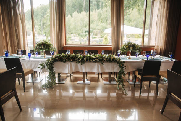 istock Decorated table for wedding celebration. Bright restaurand with a lot of windows 1030148130