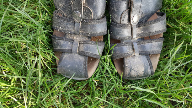 istock dirty man sandals on a grass background 1030155392