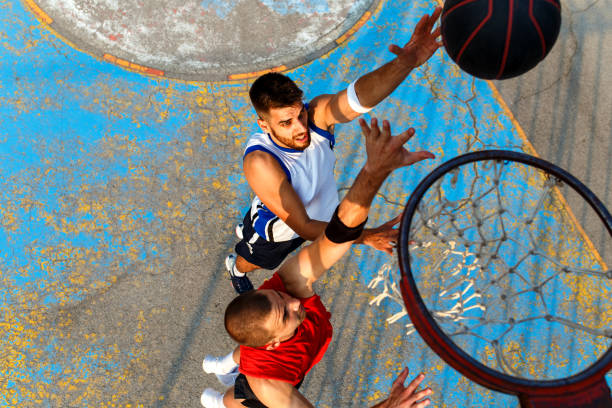istock Two young friends playing basketball. 1030160654