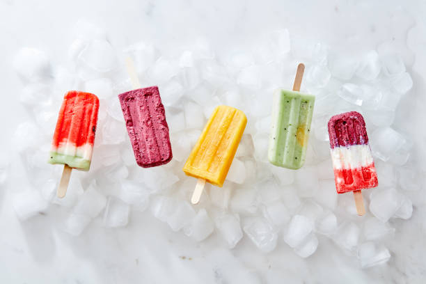 istock A set of different berry ice-cream on ice cubes on a gray marble background. Flat lay 1030161116
