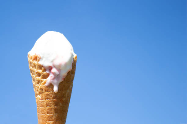 istock Ice cream in waffle cone is melting in the sun. Summer heat 1030164566