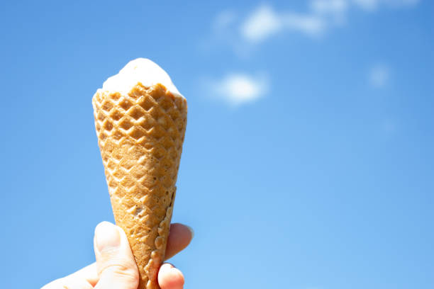 istock Ice cream in waffle cone is melting in the sun. Summer heat 1030164590