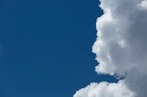 Image of a blue sky with cloud face .