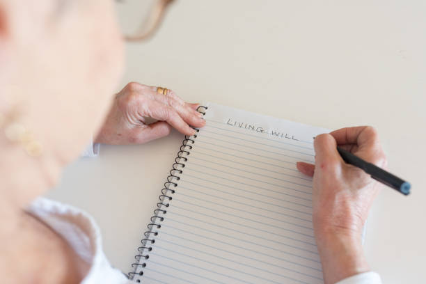 istock Older woman writing living will in notebook 1030187470
