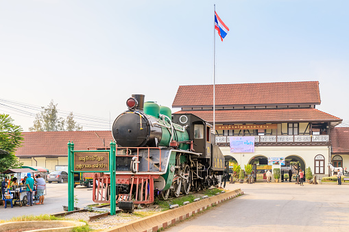 Lampang, Thailand - February 18, 2018: Historic steam locumotive displayed in front of railway station.