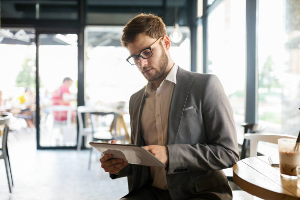 istock Busy businessman enjoying coffee while online 1030191156