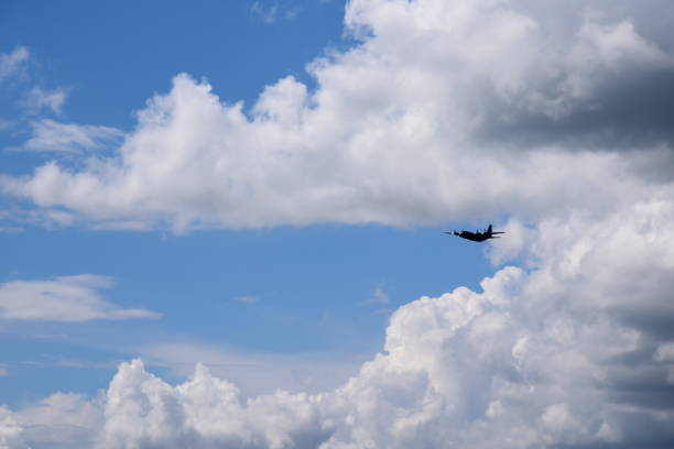 istock One big passenger plane with its rotors on flying through the sky below cloudy summer sky seen during one of trips in Poland 1030191612
