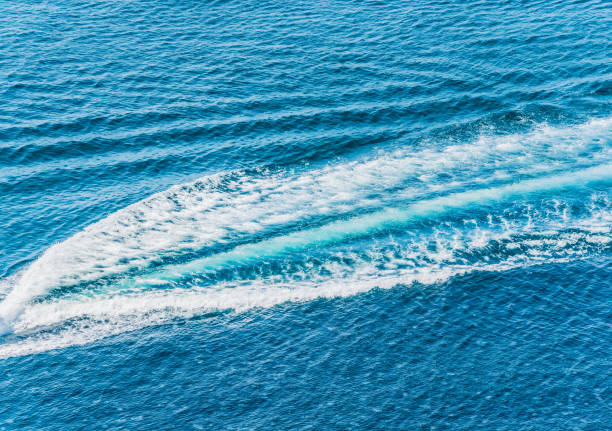 istock Trail on water surface behind of fast moving motor boat 1030207584