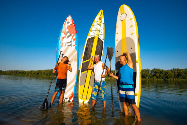 istock Joyful friends with SUP boards in their hands 1030211822