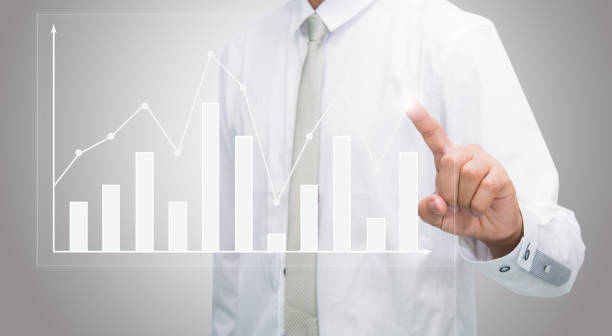 istock Businessman standing posture hand touch graph finance 1030212492