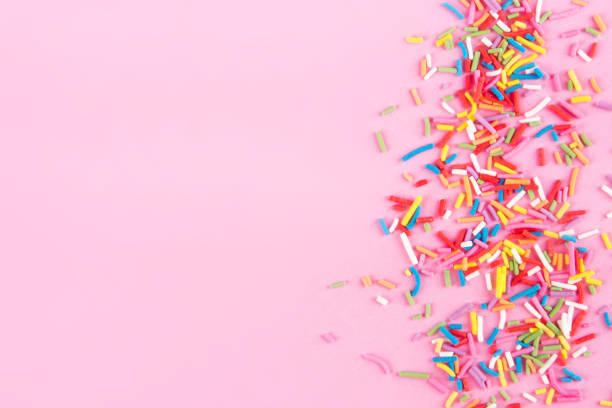 istock Sugar sprinkle dots hearts, decoration for cake and bakery, as a background. Isolated on pink. 1030215674