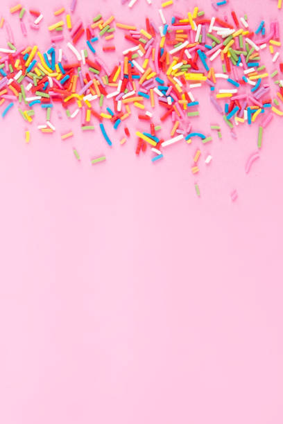 istock Sugar sprinkle dots hearts, decoration for cake and bakery, as a background. Isolated on pink. 1030215680