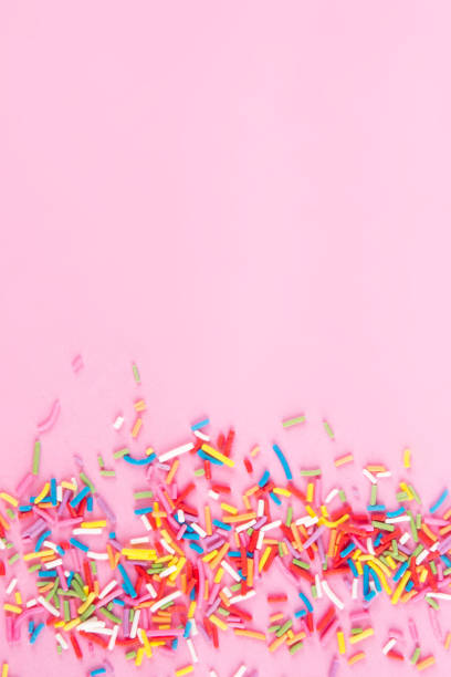 istock Sugar sprinkle dots hearts, decoration for cake and bakery, as a background. Isolated on pink. 1030215740