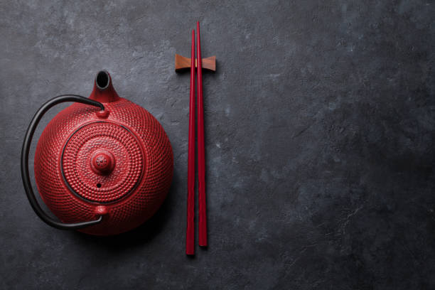 Red tea pot and sushi chopsticks Red tea pot and sushi chopsticks. Top view with space for your text. Flat lay chopsticks photos stock pictures, royalty-free photos & images