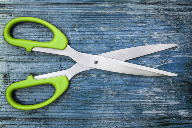 istock scissors. scissors on a wooden background. 1030218170