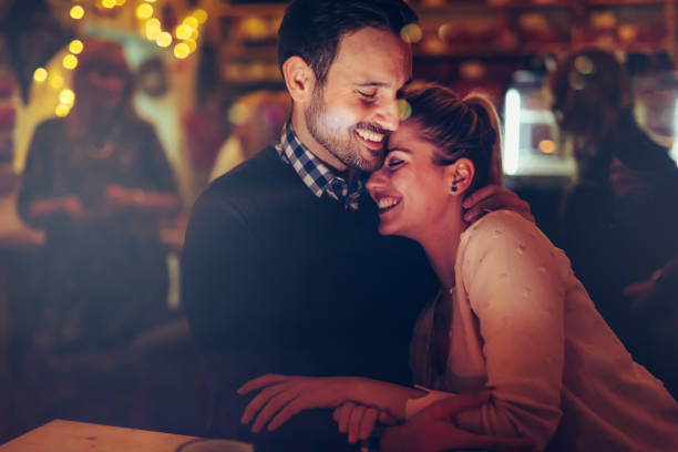 istock Romantic couple dating in pub at night 1030227648
