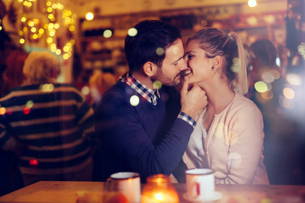 istock Romantic couple dating in pub at night 1030227768