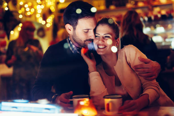 istock Romantic couple dating in pub at night 1030227946