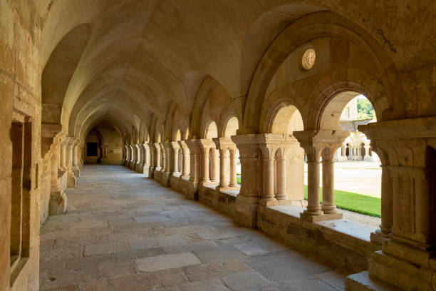Abbey Cloister and Church Fontenay Fontenay, France - July 31, 2018: Cloister with pillars of the  romanesque, Cisterian abbey and church, Cote-d'Or, France. cloister stock pictures, royalty-free photos & images