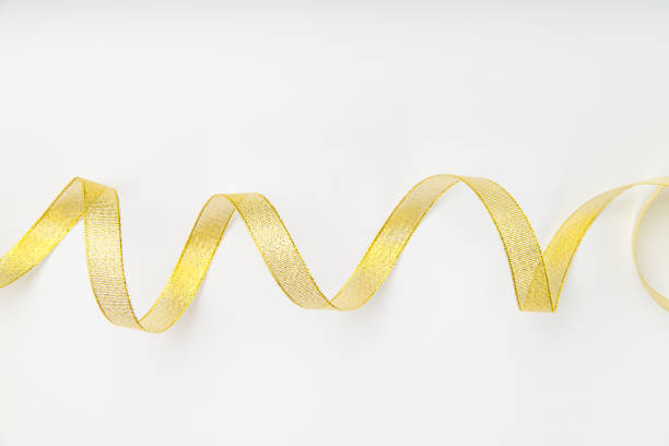 istock Shiny golden ribbon winded in spiral pattern on white background. Backdrop for text or announcement 1030242736