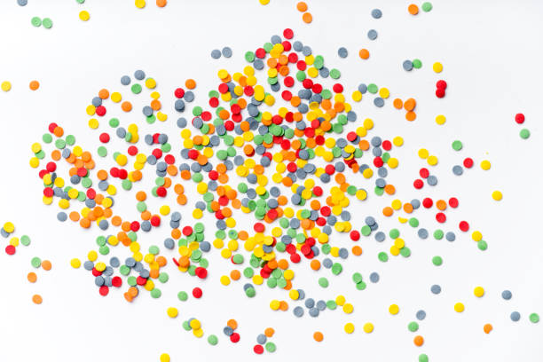 istock Colorful sweet confetti topping on white background with copy space 1030242884