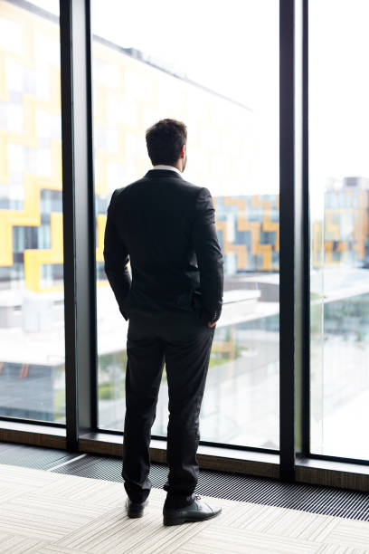 istock Pensive Businessman by Window 1030243694