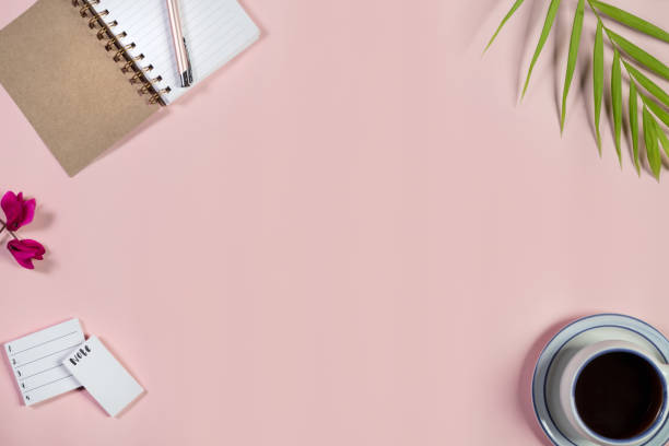 istock Directly Above View Of Open Notepad And Pen On Pink Background. 1030244214