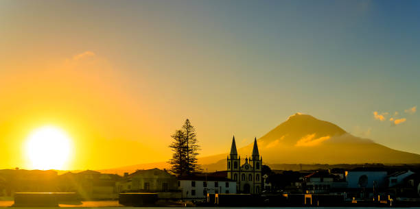 Sunrise over Madalena and Pico volcano and island, Azores, Portugal Sunrise over Madalena and Pico volcano and island  - 22september 2015 Azores, Portugal madalena stock pictures, royalty-free photos & images