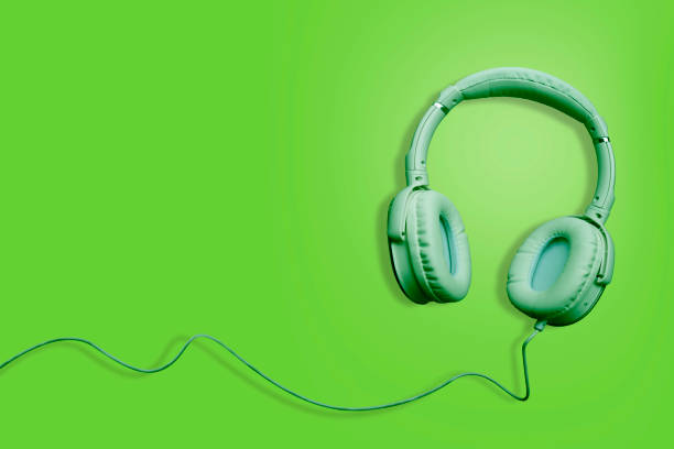 istock Headphones on green isolated background 1030250356