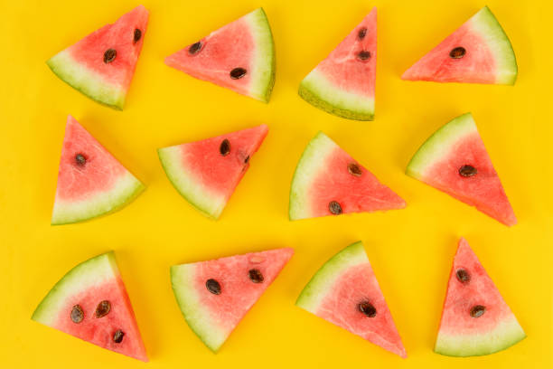 istock Sliced ripe juicy watermelon on a bright yellow background. 1030255700
