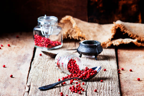 istock Pink pepper rose in a glass jar and spoon 1030260014