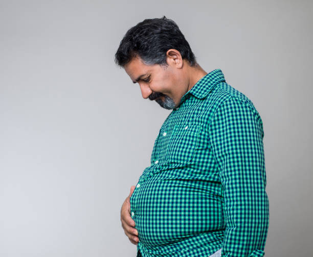 Overweight Fat man studio shot pot belly stock pictures, royalty-free photos & images