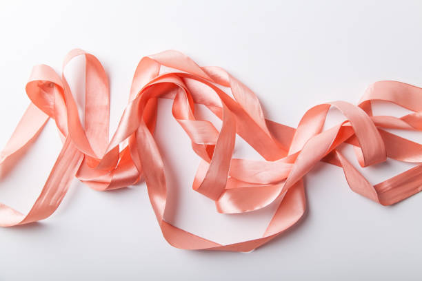 istock Shiny pink satin ribbon on white background 1030267198