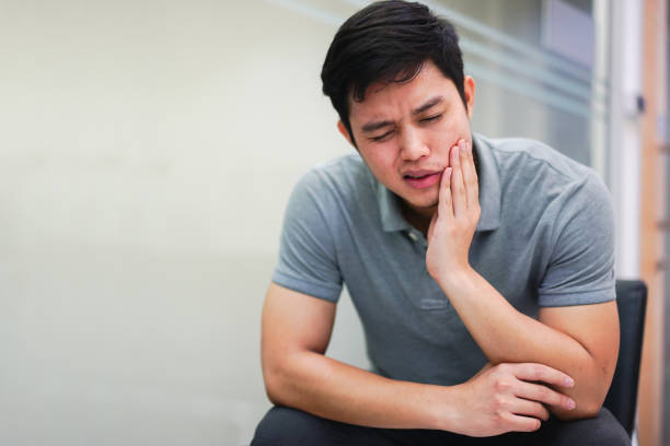 close up asian middle aged man feeling hurt from toothache symptom , unhealthy life concept close up asian middle aged man feeling hurt from toothache symptom , unhealthy life concept bad teeth stock pictures, royalty-free photos & images