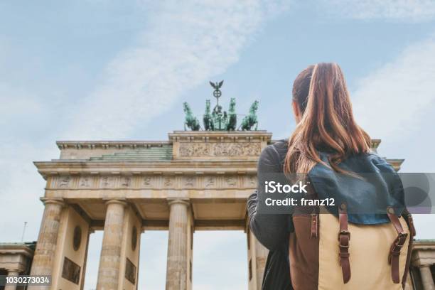 Photo libre de droit de Une Fille De Touriste Avec Un Sac À Dos En Regardant La Porte De Brandebourg À Berlin banque d'images et plus d'images libres de droit de Allemagne