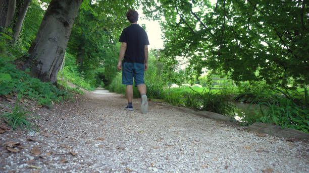 istock Causually Dressed Young Caucasian Man Walking in Idyllic Forest 1030274442