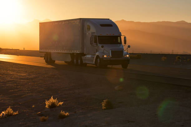 istock American style truck on freeway pulling load. Transportation theme 1030277960