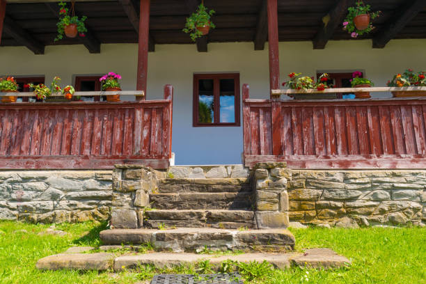 Cheia, Romania - August 15, 2018: old romanian architecture design closeup: stone stairs, wood railing and roof structure