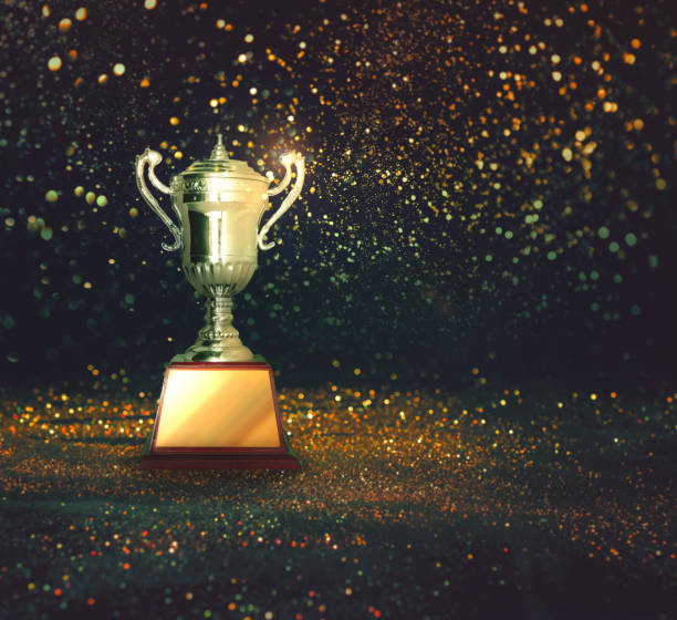 istock silver trophy on abstract gold glitter background. 1030288082