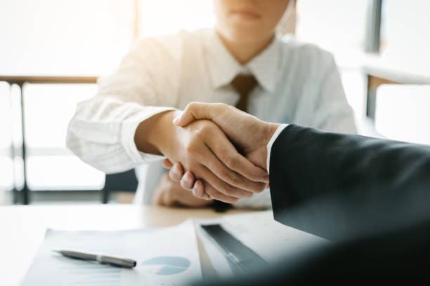 istock Businessman shaking hands with customer in office. 1030288514