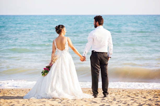 istock Bride and groom at beach 1030294322
