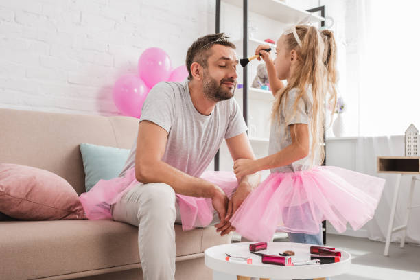 istock side view of daughter doing makeup to father 1030294458