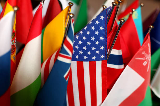 Flags of different Countries together, US-Flag in Focus Concept Picture for international Themes national flag photos stock pictures, royalty-free photos & images