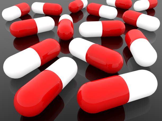 istock Pills in red and white on black background 1030295568