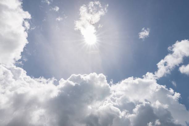 istock View into the blue sky with sun and clouds 1030295980