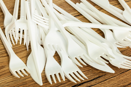 White plastic knives and forks