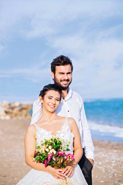 istock Bride and groom at beach 1030298494