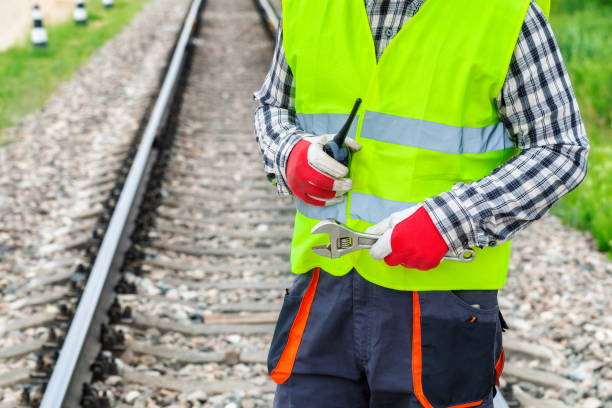istock Worker with walkie talkie and wrench on railway 1030298682
